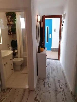 a bathroom with a sink and a toilet and a mirror at apartamento playa surf cullera in Cullera