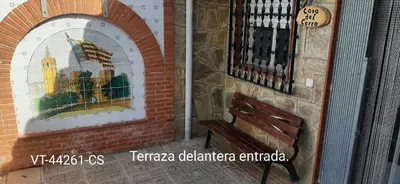 a bench next to a building with a stained glass window at Casa del Cerro in Eslida