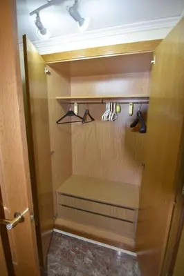 a walk in closet with hangers and shoes at MUY BIEN SITUADO LAS CIENCIAS n in Valencia
