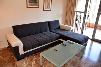 a living room with a blue couch and a table at MUY BIEN SITUADO LAS CIENCIAS n in Valencia