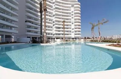 a large swimming pool in front of a large building at Espectacular apartamento en Gran cannet in Canet de Berenguer
