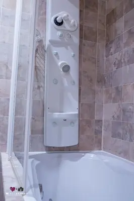 a shower with a white tub in a bathroom at Masía De Lacy in Museros