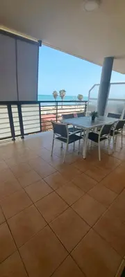 a room with a table and chairs on a balcony at Apartamento Chilches Vistas al mar in Chilches