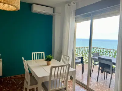 a dining room with a table and a view of the ocean at Mi Oasis Azul Parking, AC, Fibra, VT-54949-V in Sueca