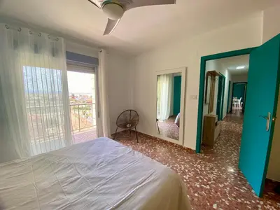 a bedroom with a bed and a large window at Mi Oasis Azul Parking, AC, Fibra, VT-54949-V in Sueca