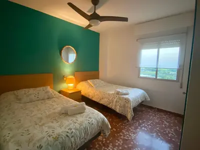 a bedroom with two beds and a ceiling fan at Mi Oasis Azul Parking, AC, Fibra, VT-54949-V in Sueca