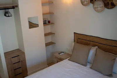 a bedroom with a bed with white sheets and pillows at Hotel Boutique - Estancia dos Olivos in Quesa