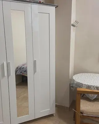a white cabinet with a mirror in a room at Casa Valencia in Valencia