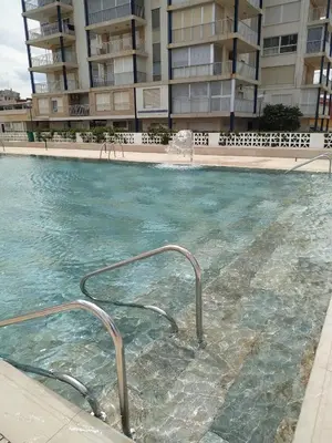 a swimming pool in front of a building at Desconexión y Relax in Mareny Blau