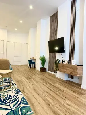 a living room with a flat screen tv on a wall at Loft Céntrico - The Essence by ValeciaGOapartments in Valencia