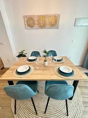 a wooden table with chairs and plates and glasses at Loft Céntrico - The Essence by ValeciaGOapartments in Valencia