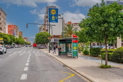 a street with a bus stop on the side of the road at Mediterraneum Apto E in Valencia