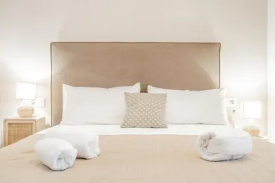 a bedroom with a bed with two towels on it at Mediterraneum Suite D in Valencia
