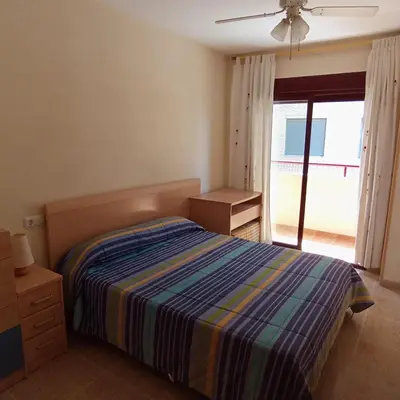 a bedroom with a bed and a large window at Apartamento 2 habitaciones playa de Canet de Berenguer in Canet de Berenguer