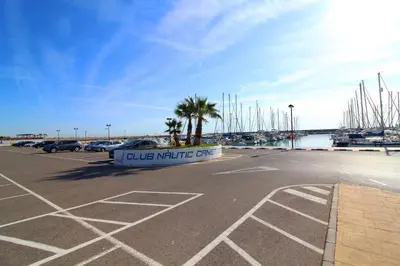 a parking lot with a sign in a marina at Global Vacacional, Apartamento con terraza de 70m y piscina en Canet de Berenguer in Canet de Berenguer