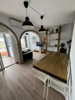 a living room with a wooden table and a couch at La Costera in Barrio-Mar