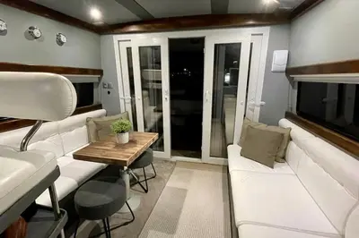 a living room with a white couch and a table at Barco Apartamento Playa Valencia in Valencia