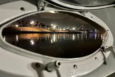 a view of a reflection of a bridge at night at Barco Apartamento Playa Valencia in Valencia