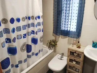a bathroom with a toilet and a shower curtain at Apartamento en la playa in Moncófar