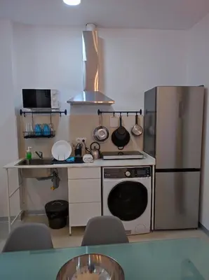 a small kitchen with a stove and a refrigerator at Valencia Beach PINK in Valencia