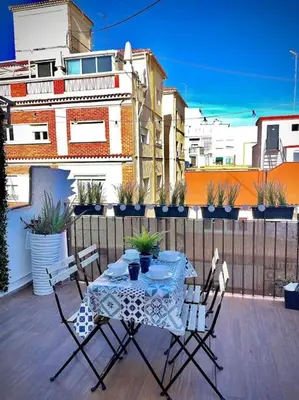 a table and chairs sitting on a balcony with a table and chairs at Elegant Rooftop by F2 Rental Home in Valencia