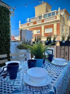 a table with plates and cups on a blue and white table cloth at Elegant Rooftop by F2 Rental Home in Valencia