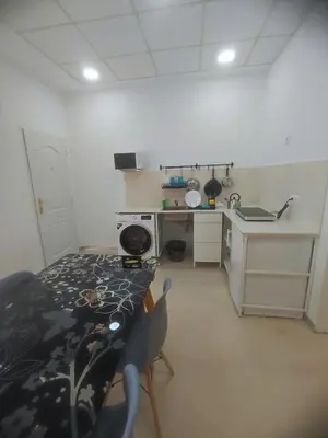 a small kitchen with a table and a stove at Valencia Beach RED in Valencia