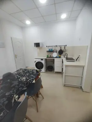 a kitchen with a table and chairs in a room at Valencia Beach RED in Valencia