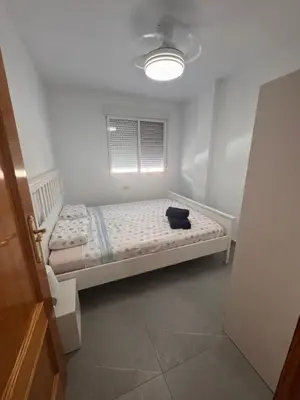 a bedroom with a bed in a room with a window at Apto 3 habitaciones, vistas al mar Moncofar Grao in Moncófar
