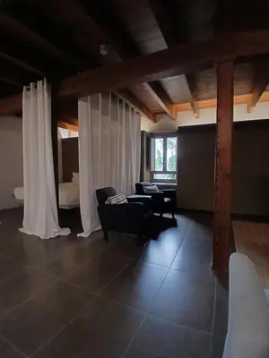 a living room with white curtains and chairs and a couch at Apartamento en molino con piscina in Paterna