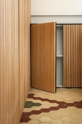 an empty closet with wooden doors and a rug at Apartamentos Maestro Sosa in Valencia