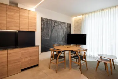 a kitchen with a table and chairs and a television at Apartamentos Maestro Sosa in Valencia