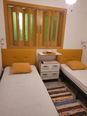a room with two beds and a window at TIGA muy cerca de la plaza de San Antonio in Cullera