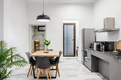 a kitchen with a wooden table and black chairs at Ruzafa Market, 2 Rooms, 5 pax,wifi ACTerrace 5 Pax in Valencia