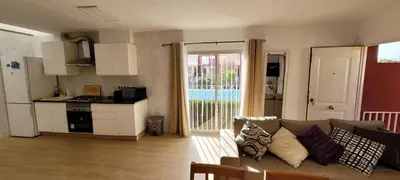 a living room with a couch and a kitchen at Adosado playa Pobla Farnals in Puebla de Farnals