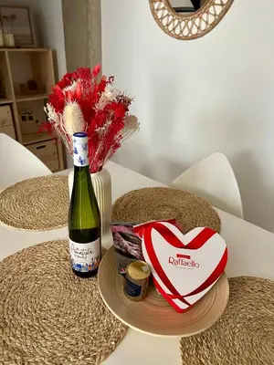 a table with a bottle of wine and a valentines box at Loft Camp del Turia A5 - Housevanlive in Valencia