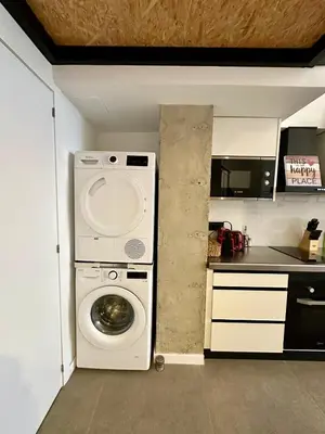 a kitchen with a washing machine in a kitchen at Loft Camp del Turia A5 - Housevanlive in Valencia