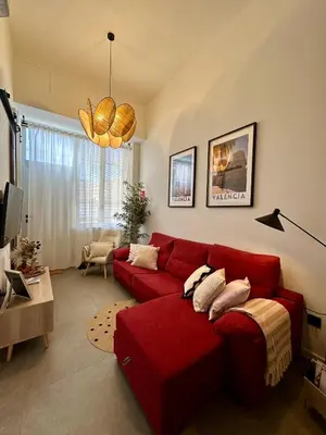 a living room with a red couch in a room at Loft Camp del Turia A5 - Housevanlive in Valencia