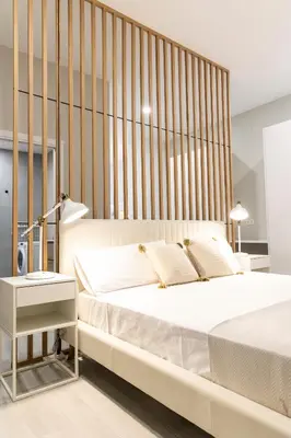 a bedroom with a large white bed with a wooden headboard at Favara Suites A by Concept Flats in Valencia