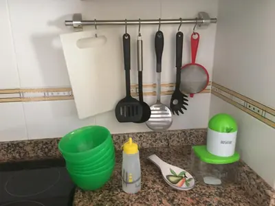 a kitchen counter with cooking utensils on the wall at BRISA de MAR in Moncófar