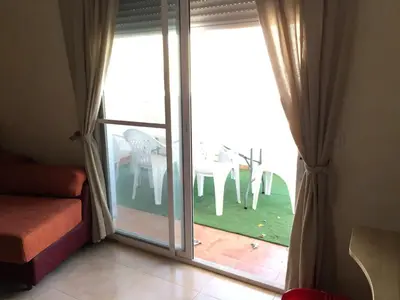 a sliding glass door with a table and chairs outside at BRISA de MAR in Moncófar