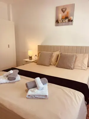 a bedroom with two beds with towels on them at Cataleya Apartment in Cullera