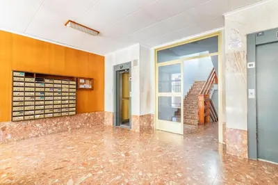 an empty room with a glass door and a staircase at Villamar ,ACC, playa wifi y garaje in Cullera