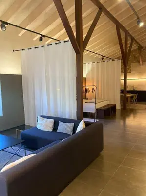 a living room with a blue couch and a table at Amazing suite by the fair in Valencia
