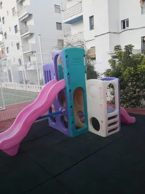 two childrens play equipment on a playground with a slide at Sea view apartment, first line on the beach, Remote work in Canet de Berenguer
