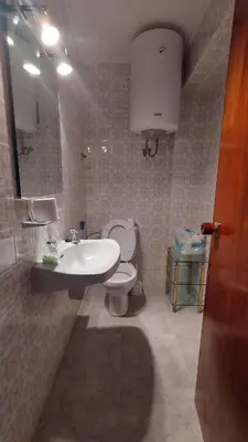 a bathroom with a sink and a toilet and a mirror at Sea view apartment, first line on the beach, Remote work in Canet de Berenguer