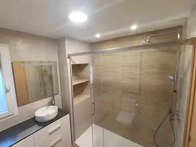 a bathroom with a shower and a toilet and a sink at Apartamento 1 linea mar terraza Port Saplaya in Port Saplaya
