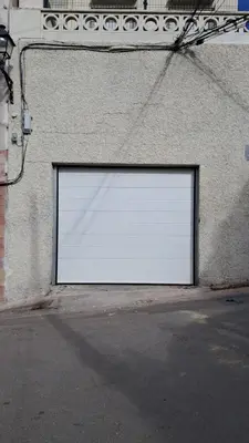 a large white garage door on the side of a building at Naquera House & Pool in Náquera