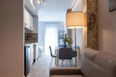 a kitchen and dining room with a table and chairs at Mediterraneo Stay in Valencia
