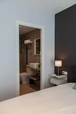 a bedroom with a bathroom with a tub and a sink at Mediterraneo Stay in Valencia